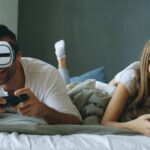 Couple playing video games with vr headset
